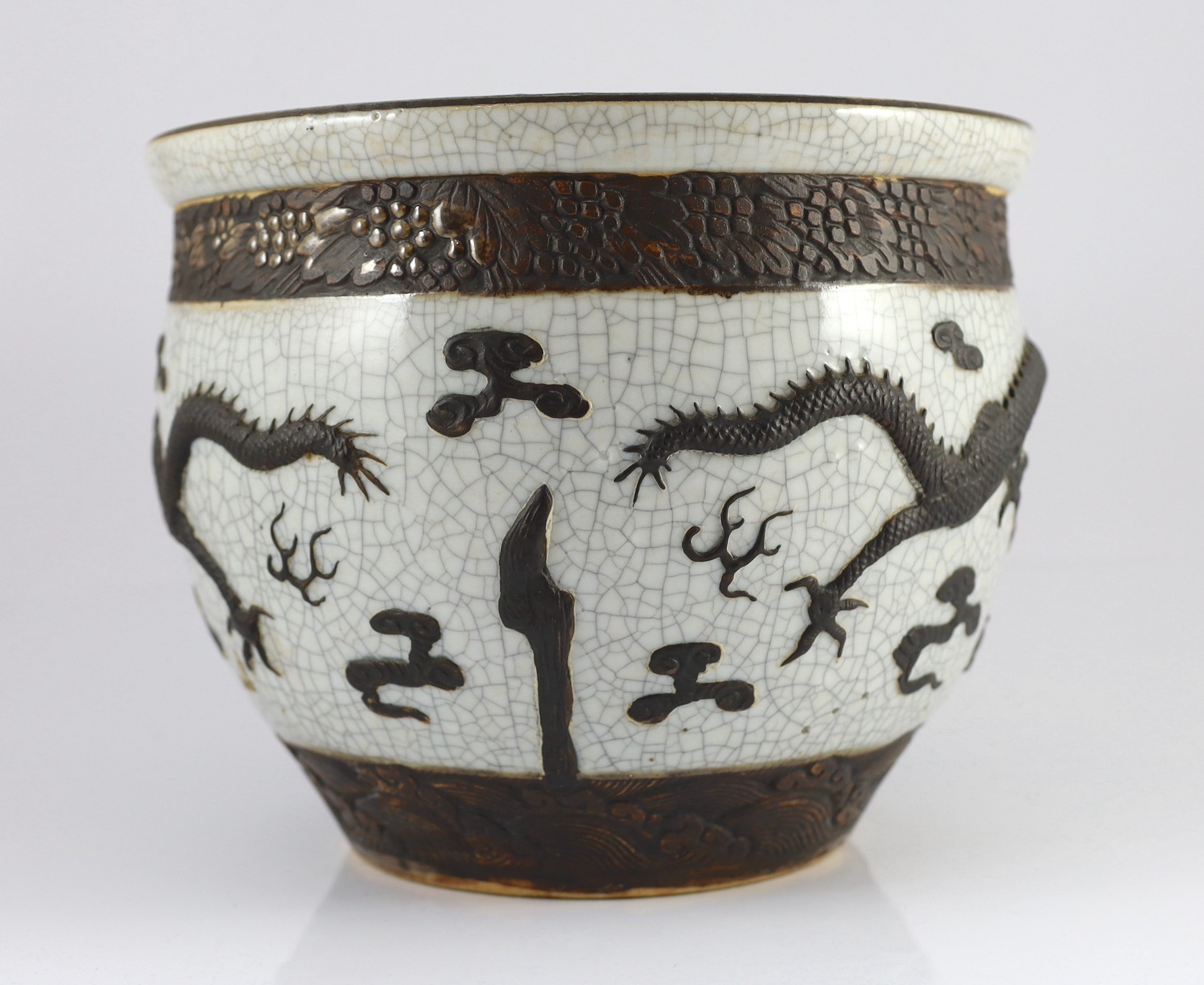 A Chinese crackle glaze 'dragon' jardiniere, late 19th century, 31.6cm diameter, 25.5cm high, star crack to base